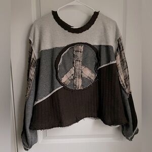 Distressed peace sign sweater